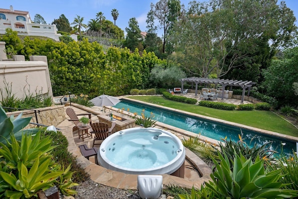 The backyard features stunning 60ft lap pool and hot tub!