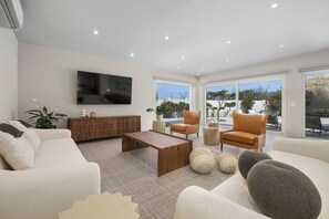 Relax in style in our spacious living room, where comfort meets elegance. With cozy seating, modern décor, and plenty of natural light, it's the perfect spot to unwind after a day of adventure.