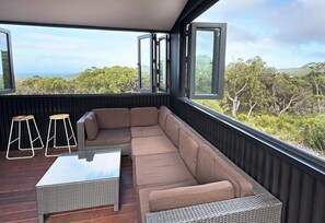 Undercover deck with stunning views. Open the windows to let the sea breeze through, close them to keep it warm.