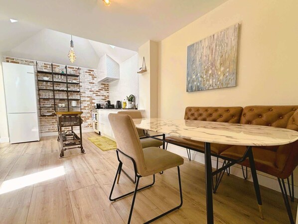 beautiful marble dining area and exposed brick, sleek shelving, bold island—industrial charm meets modern minimalism.