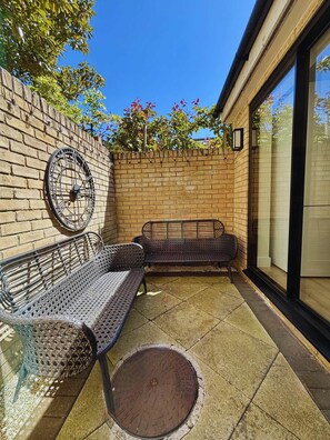 Cozy patio corner with vintage vibes—perfect for relaxed mornings or golden hour chats.