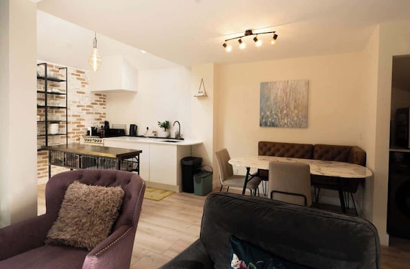 Open-plan living with a cozy lounge, stylish kitchen, and elegant dining nook—all in one inviting space.