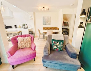 Open-plan living with a cozy lounge, stylish kitchen, and elegant dining nook—all in one inviting space.