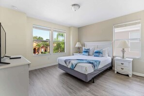 Queen size bedroom with Tv and modern blue and white decoration. 