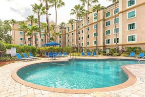 Inviting pool area with comfortable lounge chairs for relaxation.