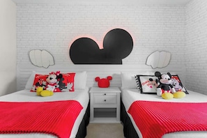 Mickey themed bedroom with two full size beds and spacious closet