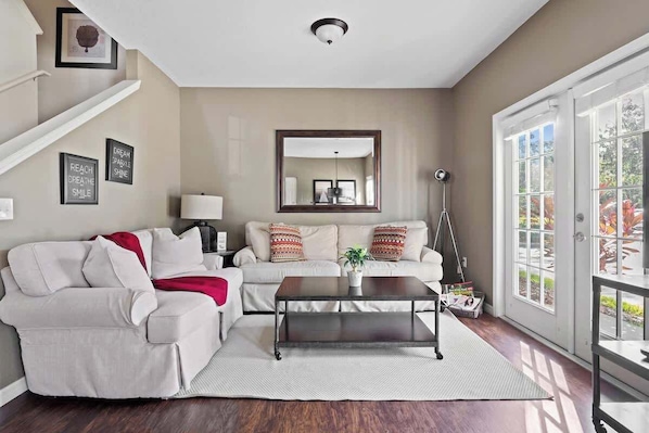 View of the living room facing the back area of the house and the dining area