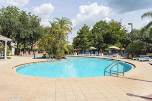 Inviting pool area with comfortable lounge chairs for relaxation.