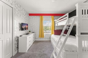 Mickey-themed bedroom, designed to delight fans of all ages! The room includes a cozy bunk bed, perfect for kids or those young at heart, ensuring a comfortable night’s sleep.
