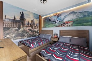 A themed Harry Potter bedroom with two full size beds and a TV will comfortably accommodate four people.