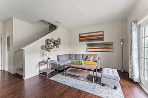 This open-concept living room features a modern sectional couch that invites you to relax in comfort and style.
