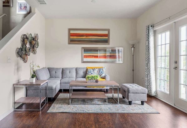 This open-concept living room features a modern sectional couch that invites you to relax in comfort and style.
