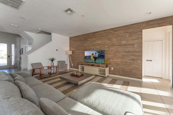 An open concept living room with charming and modern decoration.