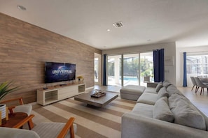 An open concept living room with charming and modern decoration.