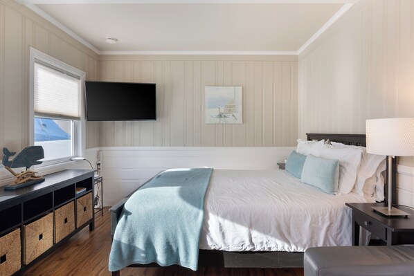 Cozy studio space with a plush bed and calming décor for a restful stay.