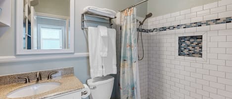 Sparkling clean bathroom with a modern walk-in shower.
