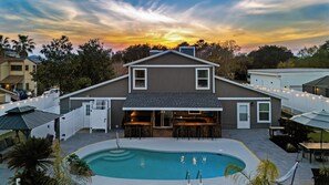 Stunning backyard oasis with a pool and sunset views.