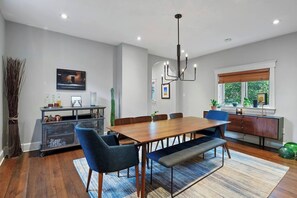 Gathered around the table, where conversations flow as freely as the aroma of home-cooked meals. Welcome to our dining haven.