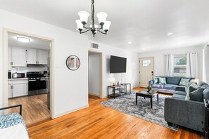 Enjoy the charm of our living room with beautiful wood floors, elegant cabinetry, and cozy furnishings. Your perfect retreat awaits! 🏡✨