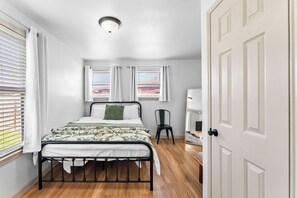 Experience comfort in our cozy bedroom with a plush bed, stylish chair, and plenty of natural light. Elegant decor and thoughtful design make this the perfect retreat. 🛏️✨