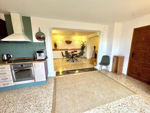 spacious living room with kitchen and dining area