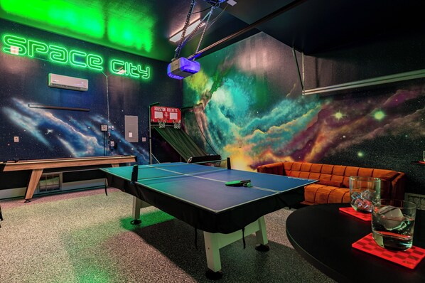 Step into Houston’s coolest game room, where galactic vibes meet non-stop entertainment! Whether you're looking to challenge friends in a ping pong match, shoot hoops, or just relax with a drink, this space-themed retreat has everything you need for a fun-filled stay.