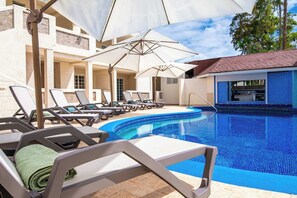 Relax by our shared pool; towels provided.