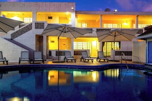 Poolside glow at sunset. Pure Barbadian magic.