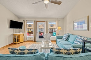 The living room looks out to the upper level balcony