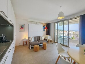 livingroom w/ open kitchen and terrace access