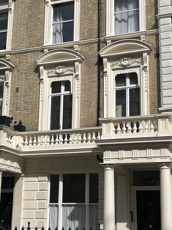The first floor apartment with the balcony and original windows