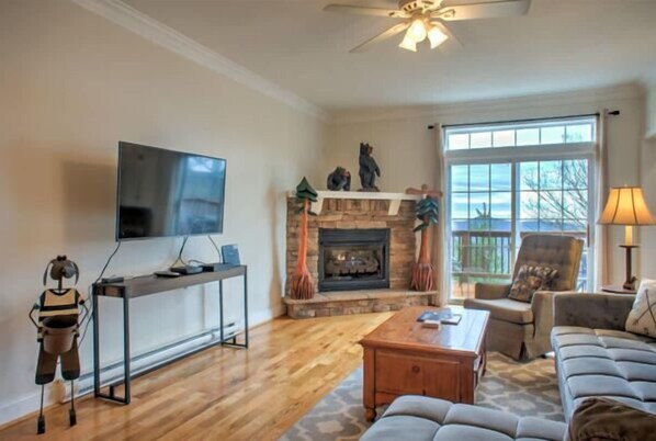 Cozy space with TV, fireplace, and comfortable seating.
