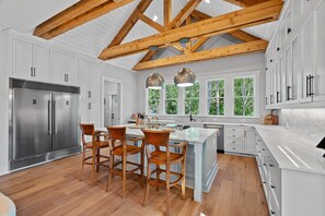 Fully stocked kitchen with island seating for 3.