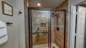 The immaculate glass-enclosed walk-in shower in the king suite private bathroom provides a spa-like experience for your personal hygiene routine.