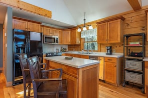Kitchen with drip-style coffee maker, dishwasher, and breakfast bar seating for 2
