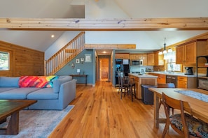 Open-concept main floor with cozy living area, dining, and kitchen