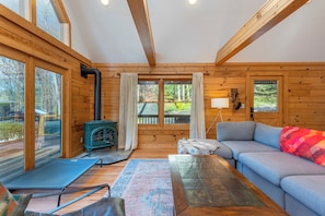 Open-concept main floor with cozy living area, dining, and kitchen