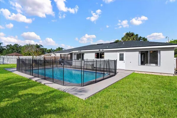 Heated pool with safety fence