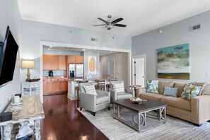 Modern kitchen connected to spacious dining and living areas.