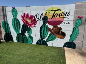 Colorful mural by the pool adds a vibrant, artistic touch to your outdoor oasis.