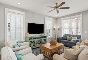 Inviting living room with comfortable seating and a smart TV for added entertainment.