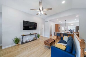 Living Room: The living room features a large TV and comfortable seating.