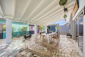 Spacious covered patio, perfect for outdoor dining and relaxation.