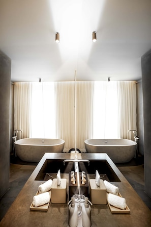 Suite 3 bathroom with double showers and a deep soaking tub
