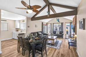 Coastal retreat with dining for six, 60" TV, ceiling fan, & ocean-view balcony.