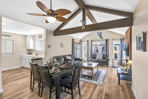 Coastal retreat with dining for six, 60" TV, ceiling fan, & ocean-view balcony.