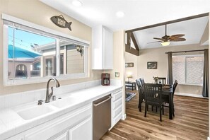 Kitchen opens to dining room & front balcony views.