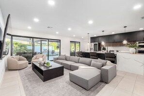 Relax in the spacious living room with cozy seating and a smart TV.