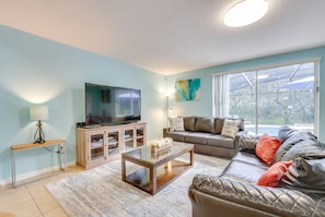 Living room with cozy seating, perfect for relaxing or entertaining after a day at the parks!