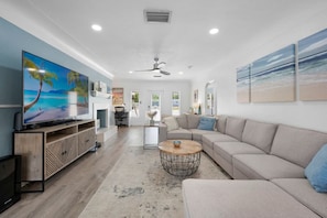 Kick back and relax in the cozy living room with comfy seating and a Smart TV, perfect for movie nights or lazy mornings.